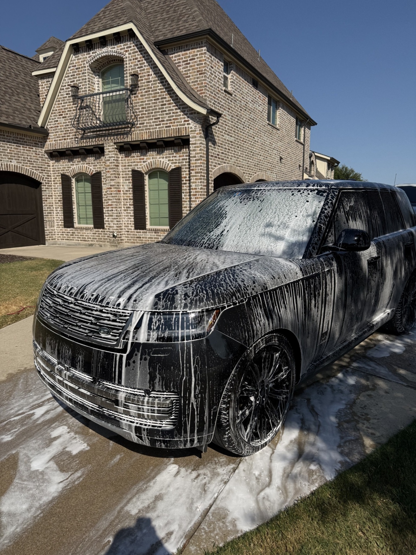 Black Range Rover foamed up in a driveway